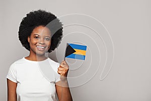 Bahamian woman holding flag of Bahamas Education, business, citizenship and patriotism concept