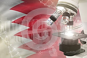 Bahrain science development digital background - microscope on flag. Research of genetics design concept, 3D illustration of