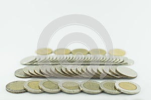 Baht Thailand coins stacked on white background.
