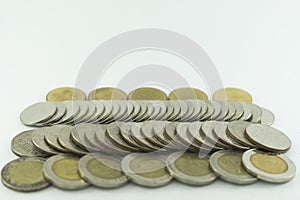 Baht Thailand coins stacked on white background.