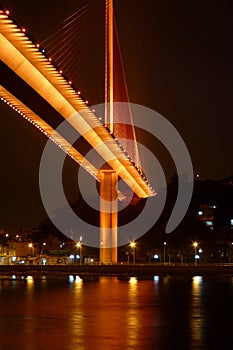 Bai chay bridge in halong bay Vietnam lit up with orange gold lighting