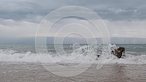 Baikal surf in inclement weather. Olkhon Island beach on Lake Baikal, cloudy