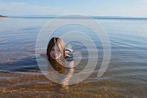 Baikal young, beautiful girl smiling floats