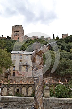 Bailaor sculpture in Paseo de los Tristes with the Alhambra and the Reuma hotel in the background photo