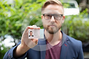 Bailiff standing at entrance showing id photo