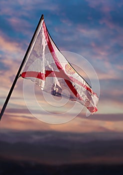 Bailiwick of Jersey flag, Jersey flag waving on sky at dusk