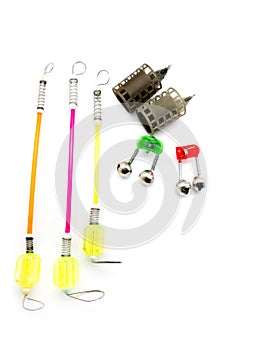 Bait feeder, bite alarm and fish bells isolated on white background. Composition of signaling devices for fishing.