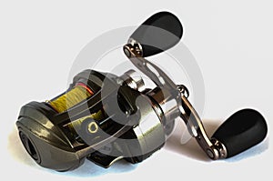 Baitcasting reel on a white background.