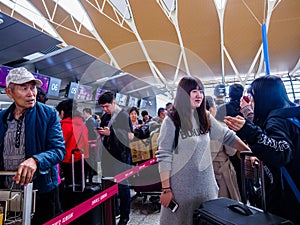 BAIYUN AIRPORT, GUANGZHOU, CHINA - 13 MAR 2019 -  Asian Chinese travellers / Passengers queue up to check-in before their flight