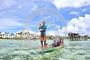 Bajau Laut kids on a boat in Maiga Island on