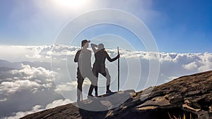 Bajawa - A couple walking above the clouds photo