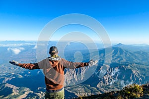 Bajawa - A man standing on the top of the volcano, admiring the view