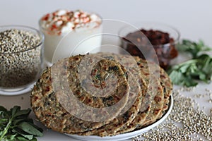 Bajra methi thepla. Indian flat bread made of pearl millet flour, fenugreek leaves, sesame seeds, yogurt and spices. Served with