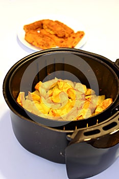 Baked American potatoes in a deep fryer