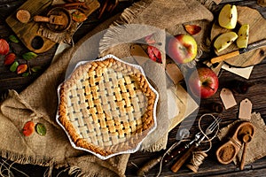 Baked apple lattice pie crust on sackcloth on rustic wooden table