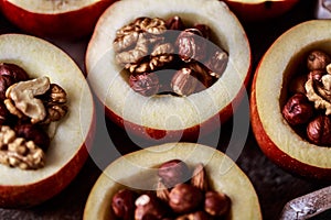 Baked apples with cinnamon on rustic background. Autumn or winter dessert. Closeup photo of a tasty baked apples with christmas de