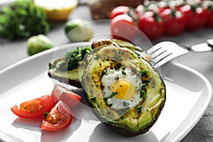 Baked avocado with eggs on plate