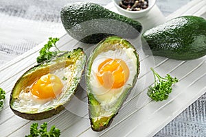 Baked avocado with eggs on table