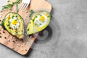 Baked avocado with eggs on table