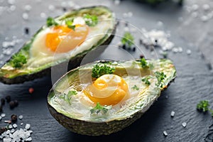 Baked avocado with eggs on table