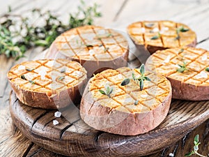 Baked batata on the old wooden table photo