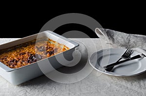 Baked bean casserole on a white linen tablecloth