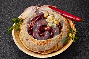 Baked bean dish in bread crust. Mexican food