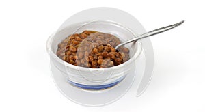 Baked beans in old bowl with spoon