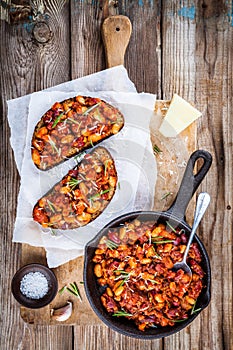 Baked beans with rosemary and parmesan on toast