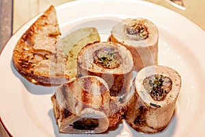 Baked beef bones with bone marrow are on a plate
