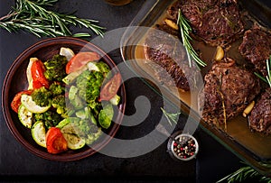 Baked beef steak with garlic and rosemary and vegetables