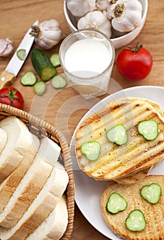 Baked bread, milk and vegetables for breakfast