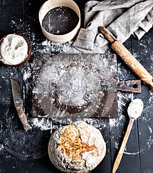 Baked bread, white wheat flour, wooden rolling pin