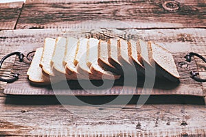Baked bread on wooden table background