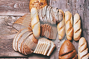 Baked bread on wooden table background