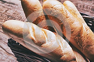 Baked bread on wooden table background