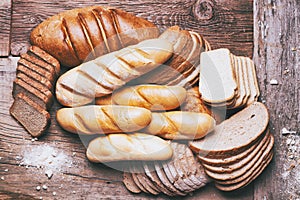 Baked bread on wooden table background