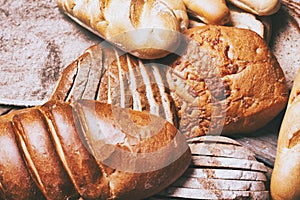 Baked bread on wooden table background