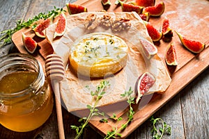 Baked camembert cheese with figs, walnuts, honey and thyme on the rustc background photo