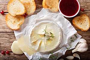 Baked camembert cheese with thyme and garlic served with roasted