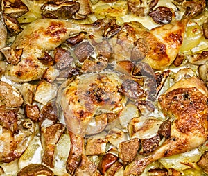 Baked chciken drumsticks with potatoes and mushrooms