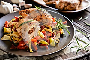 Baked chicken breast stuffed with cheese, tomato and basil with rice and steamed vegetable salad