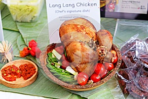 Baked chicken cooked in Indian style with tomato and cucumber in a bowl