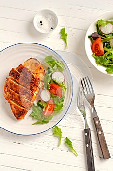 Baked chicken fillet in a vintage plate