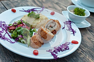 Baked chicken rolls with vegetable salad and mashed potato