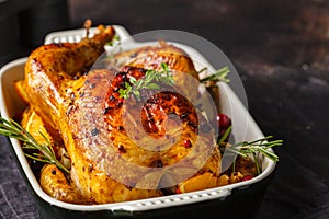 Baked chicken with spices, cranberries, orange and onions in a glass dish