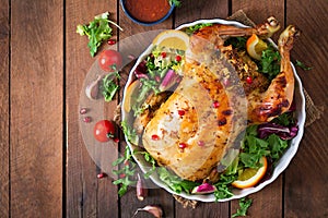 Baked chicken stuffed with rice for Christmas dinner on a festive table.