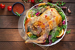 Baked chicken stuffed with rice for Christmas dinner on a festive table.