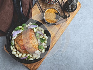 Baked chicken thigh with white beans in a portion pan