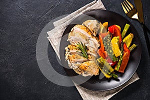 Baked chicken with vegetables top view.